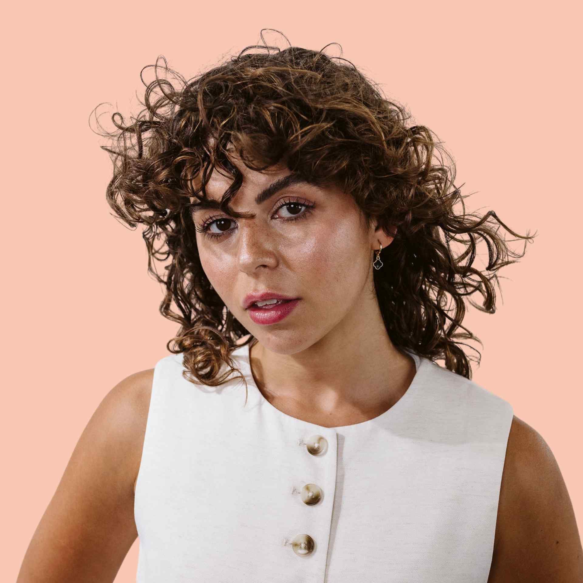curly haired girl staring at camera