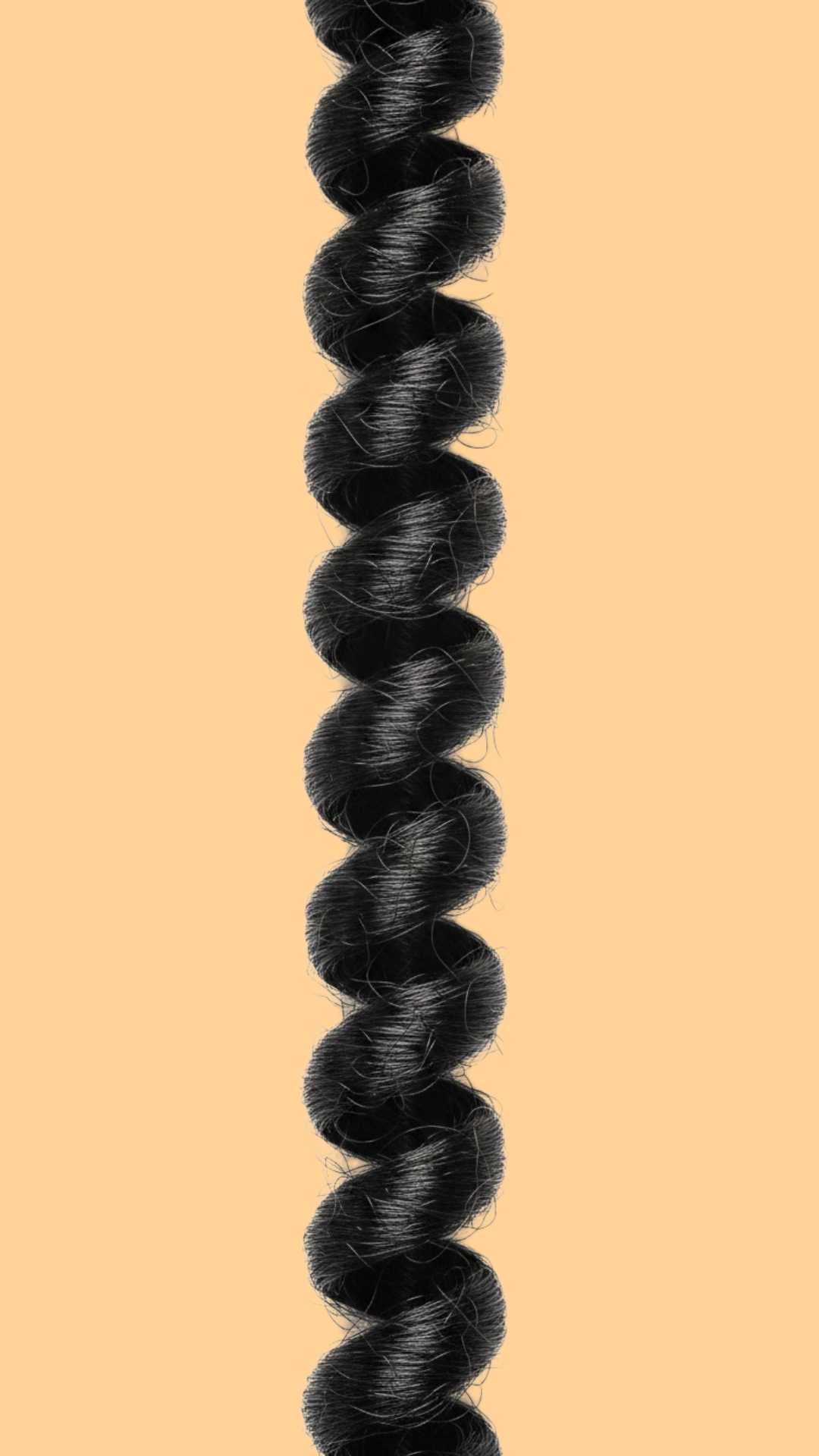 coily hair clump on an orange background