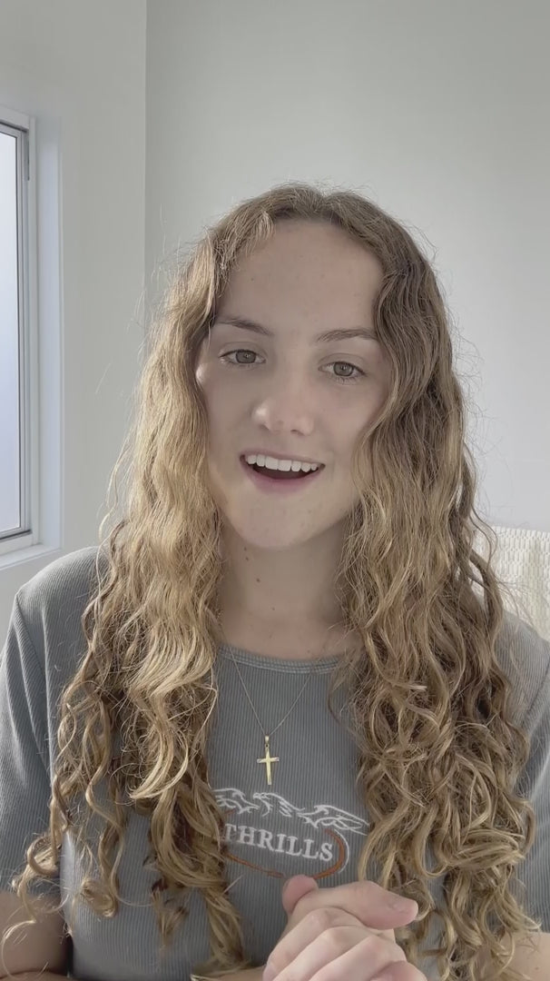 woman with brunette blonde wavy hair shows how to perform LOHY. hero routine which turns her frizzy hair to soft defined curls