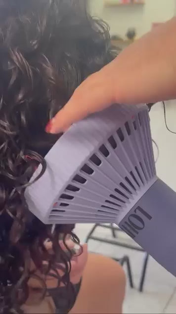 Close up of the curl flow being used on curly hair dark hair, orange and purple diffuser 
