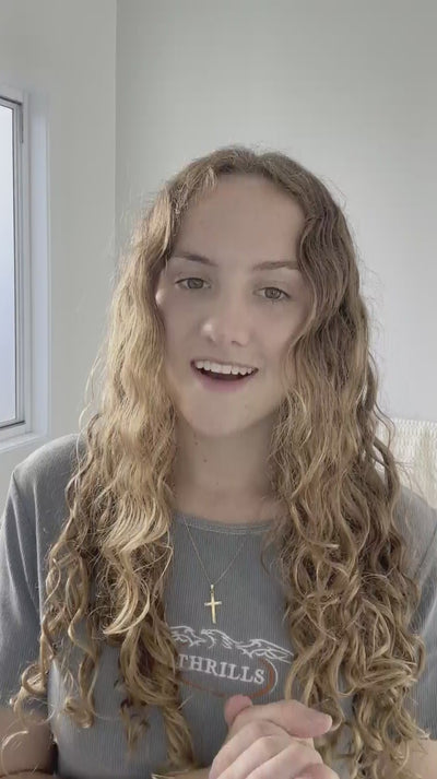 brunette red haired curly hair model, defines and shows how to do a hero routine on curly wavy hair with LOHY.