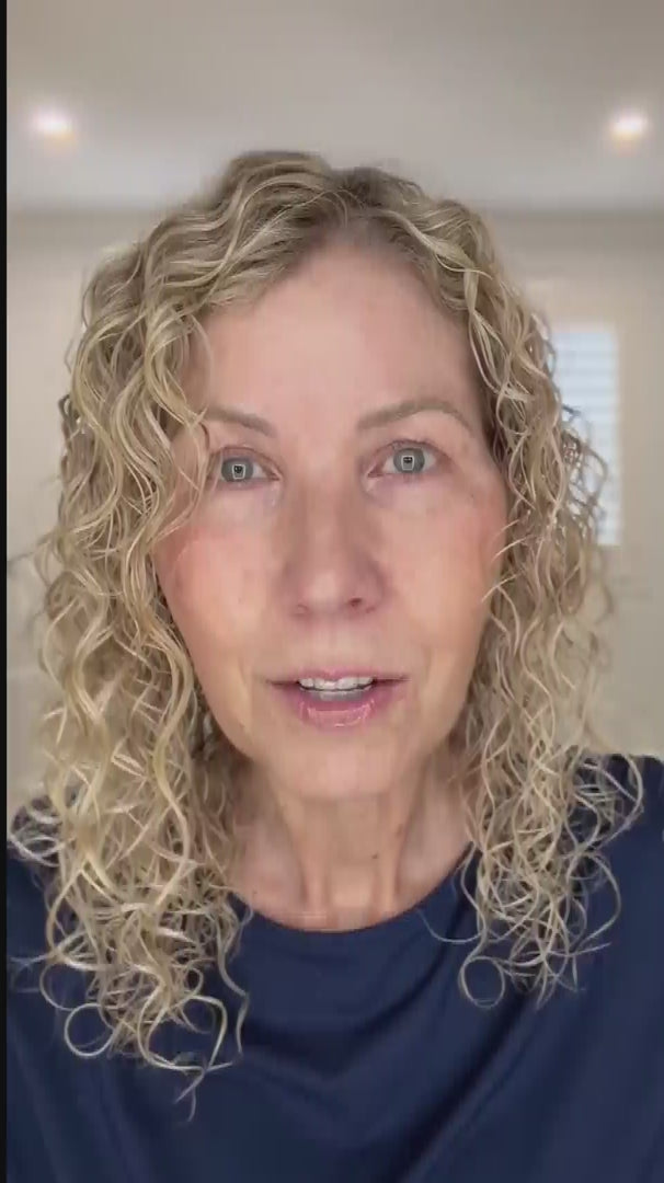 Load video: wavy haired, blonde hair lady showing LOHY's universal curl flow diffuser and defined soft curly hair results