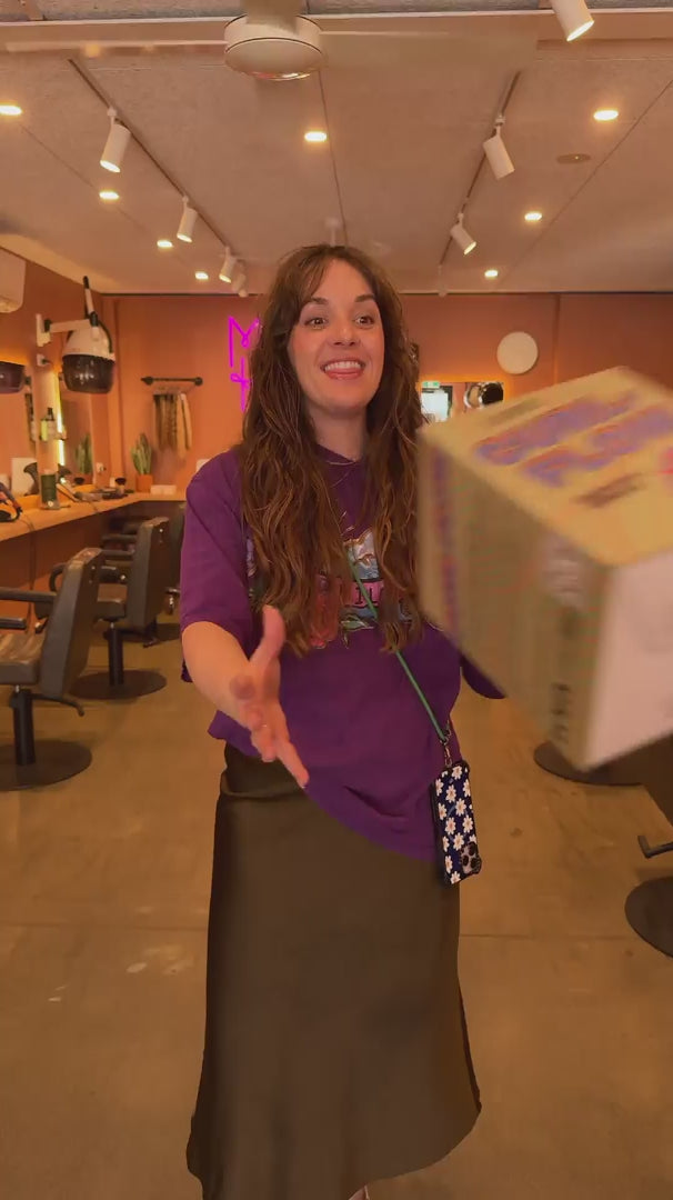 wavy brunette haired owner of LOHY. showing why they created the curl-flow universal diffuser